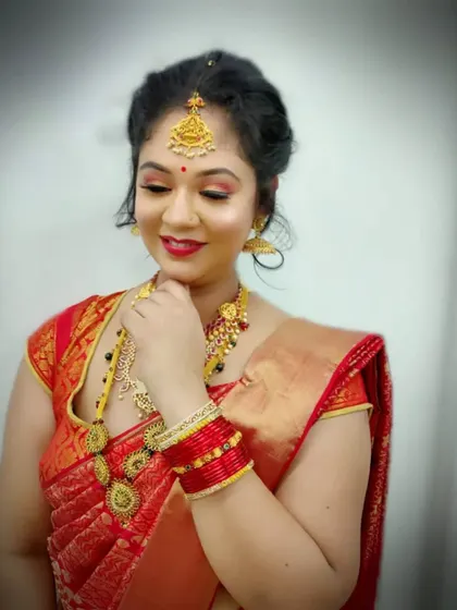 A beautiful example of a South Indian bridal look, featuring warm, glowing makeup with a classic red lip. Our students learn to perfect this style, which is always in high demand.