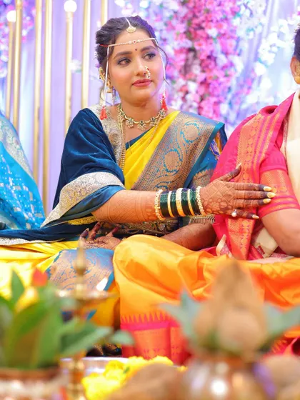 The bride during her wedding ceremony, looking poised and beautiful. The makeup is subtle enough to let her natural grace shine.