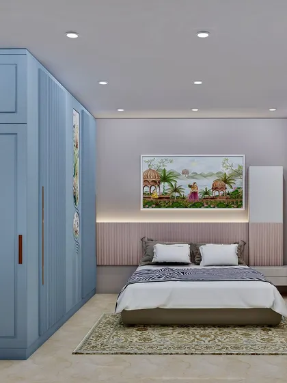 A serene bedroom design with pastel blue wardrobes, a soft pink headboard wall, and traditional Indian art, creating a calm and cultured space.