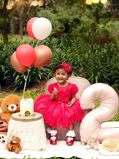 A full view of the adorable second birthday setup. The number '2' balloon and picnic props create a perfect party scene.