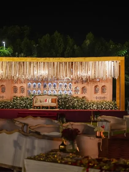The reception stage set against the night sky, showing how the warm lighting and traditional architecture create an inviting and regal focal point.