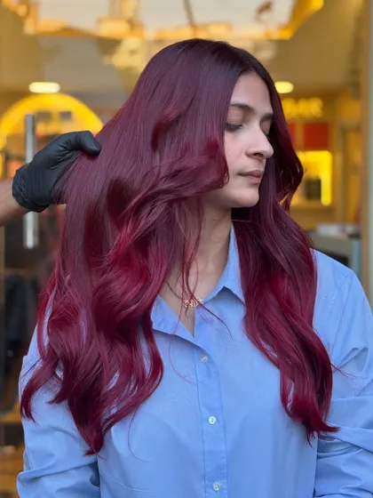 Shades that speak louder than words. This magenta-red look is vibrant and playful, perfect for anyone looking to express their personality through their hair.
