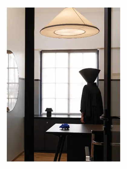Another custom light fixture from the 'Shadows' project. The conical shape of the light echoes the conceptual art in the photoshoot, creating a cohesive and thematic design language throughout the office space.