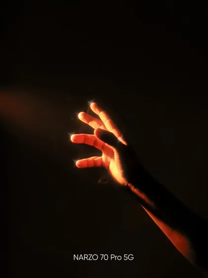 A conceptual low light photo of a hand reaching into a beam of light, creating a sense of magic and wonder.