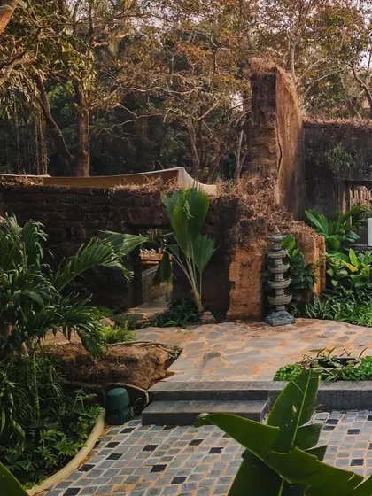 The weathered stone ruins at Sanctuary Bar, which form the backbone of the landscape design. The space is designed to feel like a hidden discovery, blending history with nature.