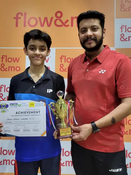 Hard work pays off. Here I am with one of my dedicated students after his win at the 'My Game Open Badminton Tournament'. This is the result of consistent effort and disciplined training.