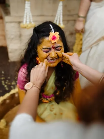 A candid moment of a bride enjoying her Haldi ceremony. We focus on capturing the genuine smiles and happy tears.