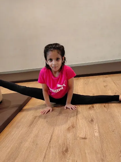 Working on oversplits! We use safe stretching techniques to help our gymnasts improve their flexibility, a key component of the sport.