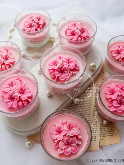 This was a custom order of bridal shower return gifts. I created these beautiful two-toned Plumeria flower candles in an ombre pink glass jar, complete with custom stickers and packaging.