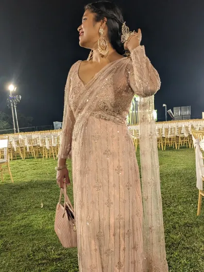 This comfortable saree-style gown is perfect for a long night of wedding festivities. The pastel pink color and all-over beadwork are elegant and timeless.
