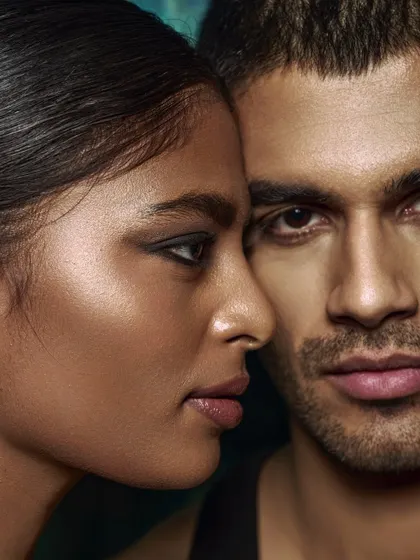 Another close-up of the couple, this time with a slightly different angle. The focus remains on the connection and the realistic depiction of skin under studio light.
