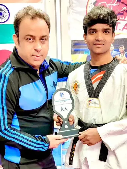 Congratulating my student Imran on his achievement and presenting him with a trophy.