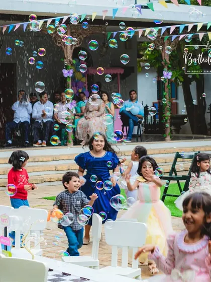 Pure happiness captured as kids chase bubbles at an outdoor party. We focus on creating moments of joy and wonder.
