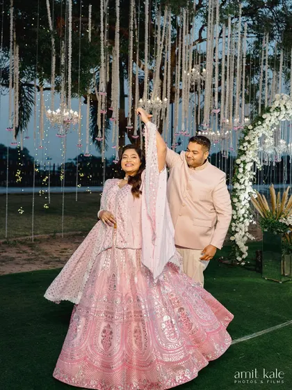 A fun, candid shot of the couple dancing at their outdoor engagement party.
