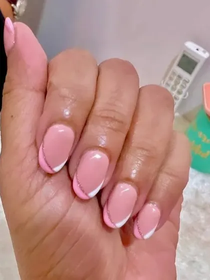 A close-up of the pink and white French manicure with the subtle glitter line, a perfect design for someone who loves a touch of sparkle.