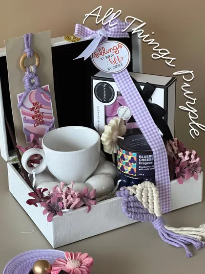 For the sister who loves a specific color palette, this 'All Things Purple' hamper is a dream. It features a beautiful ceramic mug, blueberry cheesecake dessert jar, and other purple-themed goodies.