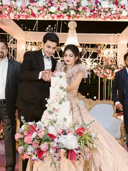 The cake cutting is such a special moment. I love ensuring the decor around it is just as sweet, with the floral stage creating a beautiful frame for the couple's celebration.