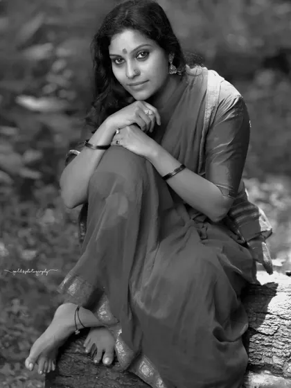 A rustic, village-themed series inspired by the movie 'Kanthara'. The model is styled in a simple red saree, captured in a natural, watery landscape to evoke a sense of raw, earthy beauty.
