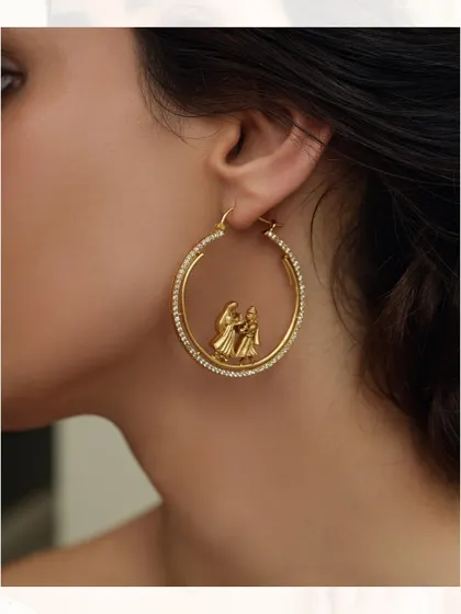 A clean product shot of our unique hoop earrings with the dancing couple motif, a perfect blend of tradition and modernity.