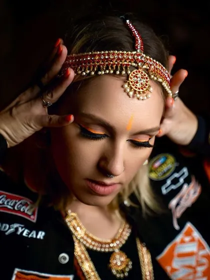 A close-up of the neon liner look I created for Uma Shanti. The bright orange is a bold choice that beautifully contrasts with the intricate traditional headpiece.