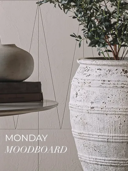 A large, white, rustic planter with a distressed finish, showcasing how we use such pieces to add character and a biophilic touch to our interiors.