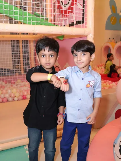 Two boys show off their matching temporary tattoos, a fun party favor and activity.
