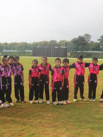 The full U-10 team lines up for a photo on the lush outfield.