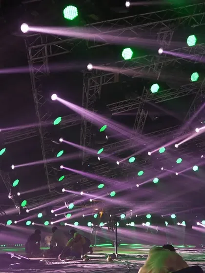 The stage floor during lighting programming for the 'Po Po' song, with beams of light crisscrossing the space.