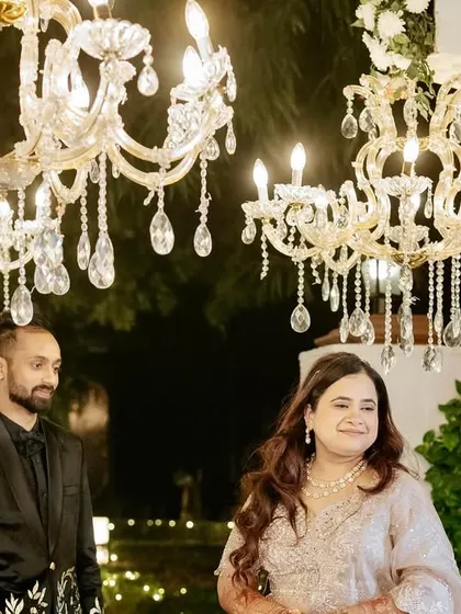 The couple enjoying a moment under the sparkling crystal chandeliers that lined their Sangeet entrance walkway.