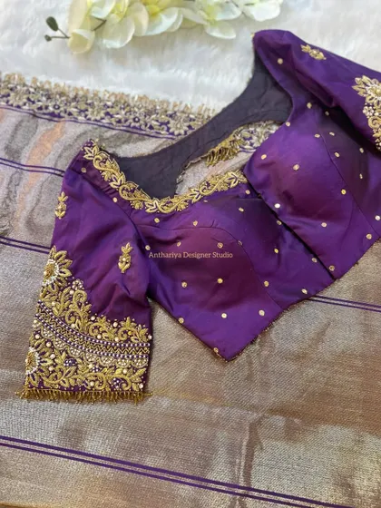 The front view of the purple blouse, with delicate pearl detailing.