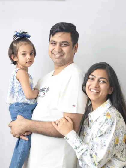 A classic family of three portrait. The simple white background and natural smiles make this a timeless and beautiful memory.