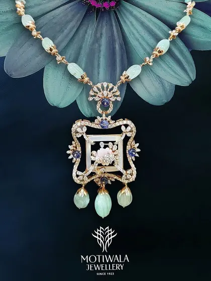 An artistic shot of a magnificent traditional necklace with a large pendant, featuring intricate enamel work and gemstones. This piece is a true work of art, blending color and tradition.