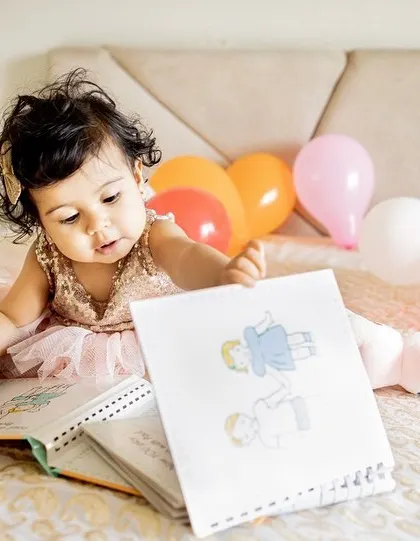 I love capturing toddlers engrossed in their favorite books. It's a sweet, quiet moment that makes for a cherished memory of their early interests.