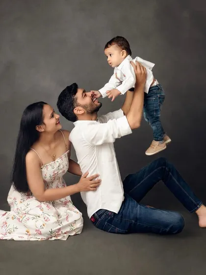 A playful moment in the studio. Lifting the baby up always brings out the biggest smiles from everyone.