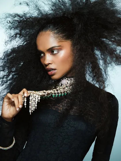 A full shot of the voluminous hair and sculpted glam look, showing how makeup and hair can work together to complement high-end jewelry and fashion.