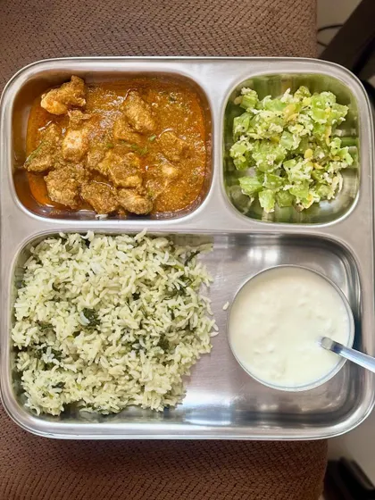 A balanced meal of dill-flavored rice, chicken curry, sautéed snake gourd, and curd.