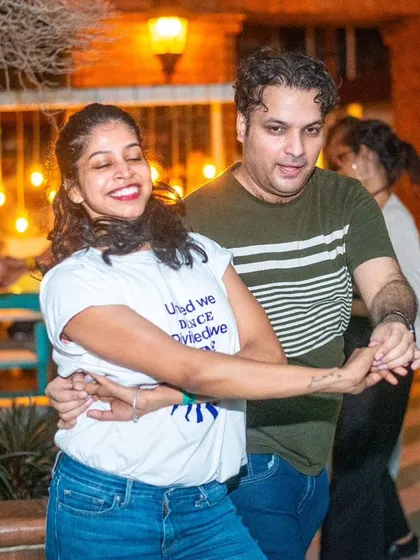A sweet and connected moment, with both dancers smiling.