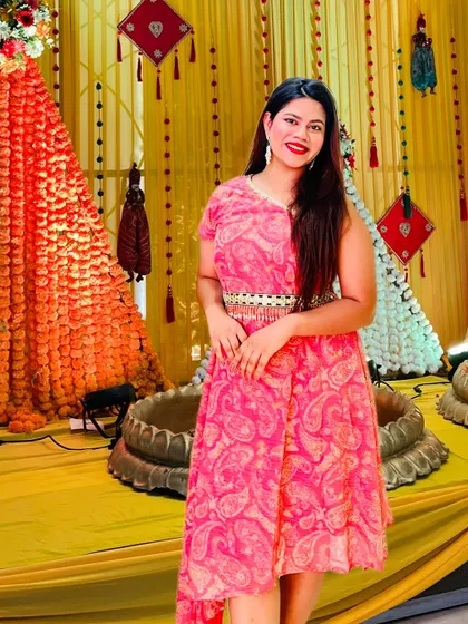 Rocking a pink dress against the traditional yellow Haldi decor. It's all about creating a fun, vibrant look.