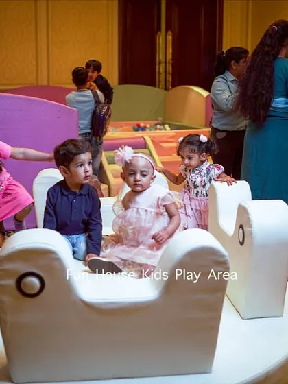 A group of young children gathered on the merry-go-round, a great social hub within the play area.