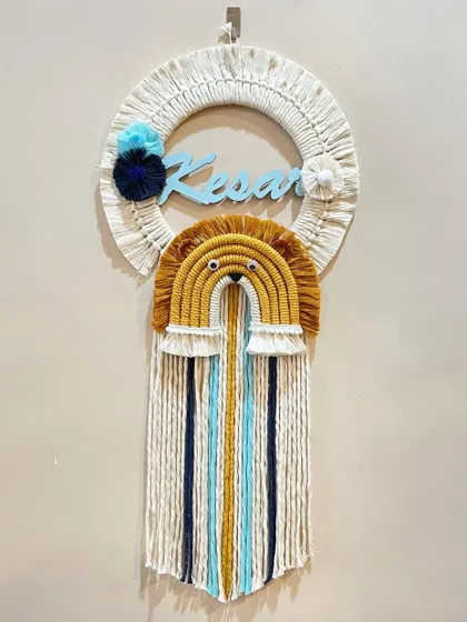 This personalized name hanging for Kesar features a brave lion rainbow design. The combination of the custom name, animal theme, and long colorful tassels makes it a standout piece for a nursery.