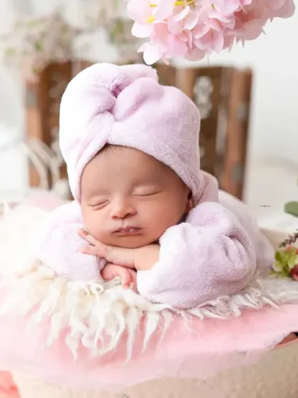 A close-up portrait of a sleeping newborn, highlighting their perfect features during a themed photoshoot. My safe posing techniques ensure your baby is always comfortable.