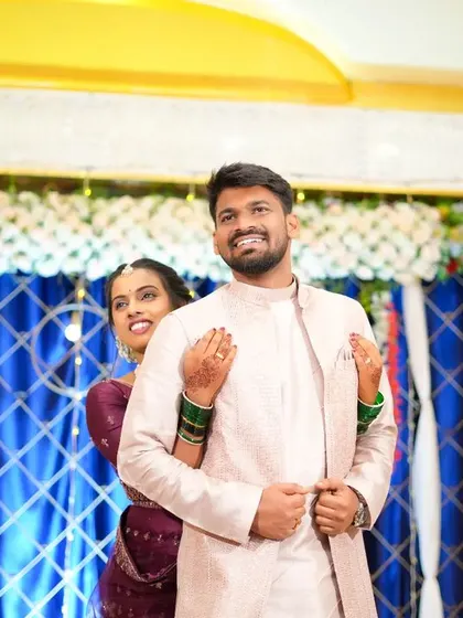 A playful moment where the bride peeks from behind the groom. This adds a fun, lighthearted feel to the wedding album.