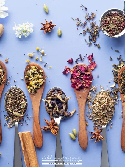 This creative flat lay showcases a variety of tea blends. Using spoons to display the loose leaves is a beautiful way to show the texture and ingredients of each unique tea.