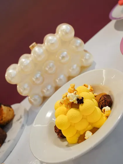 This dessert, inspired by a pearl-encrusted handbag, features a mango mousse with popcorn. It was part of our fashion-inspired menu at the Ajio Luxe Café, where every dish was a nod to a different designer.