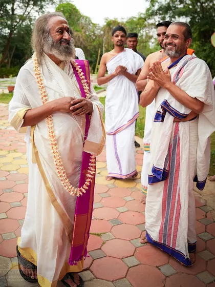 A lighthearted moment with a senior teacher after the Rudra Puja. Spirituality here is a beautiful balance of profound depth and simple, human joy.