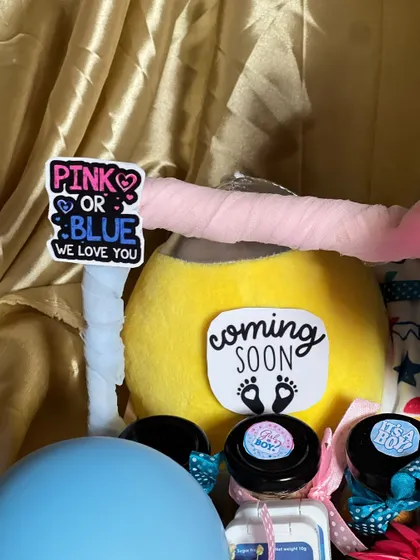 Detail of the "Pink or Blue, We Love You" and "Coming Soon" stickers. These little messages add a lot of heart to a baby shower gift.