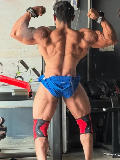Back double biceps, showing the hamstring and glute development.