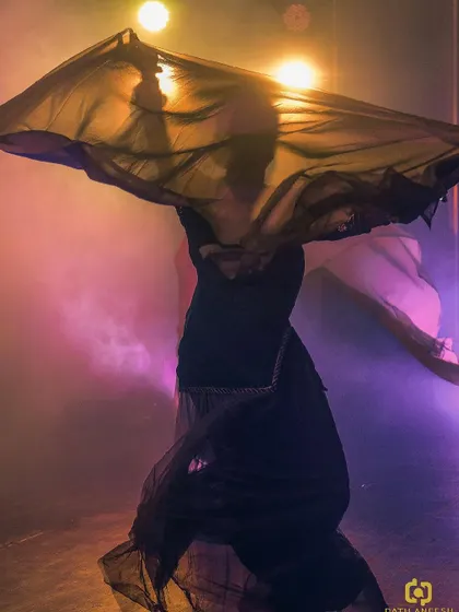 The beautiful flow of fabric and movement under the stage lights. This image captures the dramatic and artistic essence of our modern take on a Rajasthani folk tale.