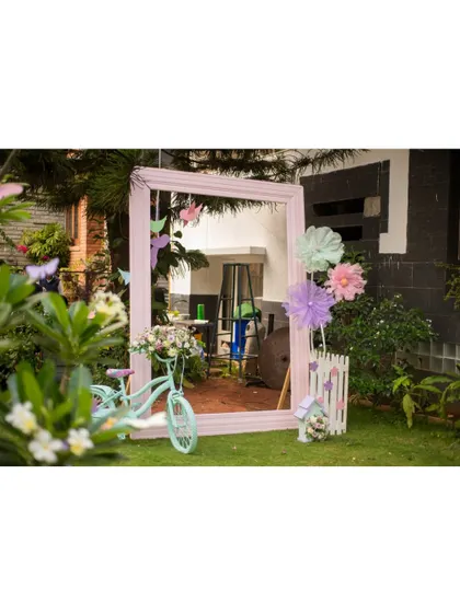Another shot of the garden photo booth, showing the large mirror and bicycle prop that create a fun and interactive spot for guests.