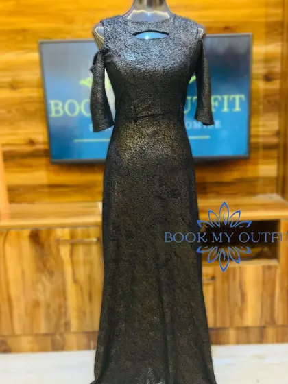 This black shimmery gown offers a subtle yet sophisticated sparkle. The cold-shoulder design and keyhole neckline add modern details to a classic full-length dress.